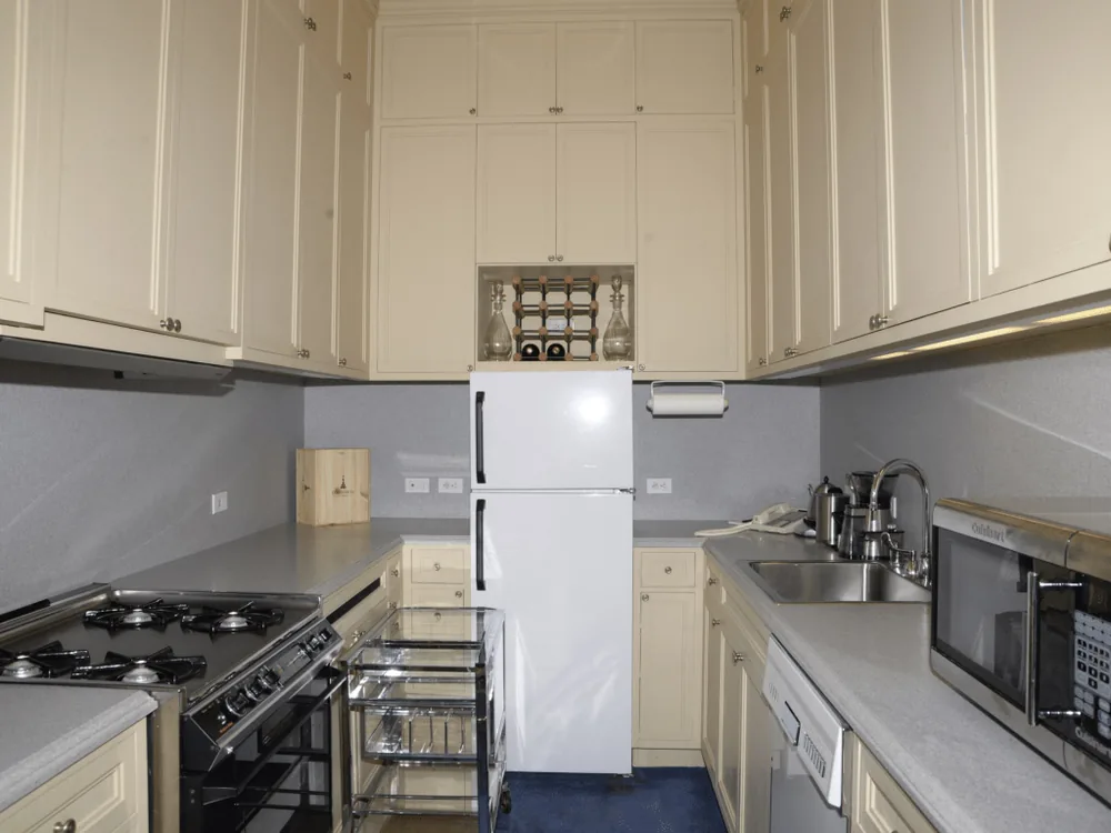 A kitchen with a white refrigerator and stainless-steel appliances