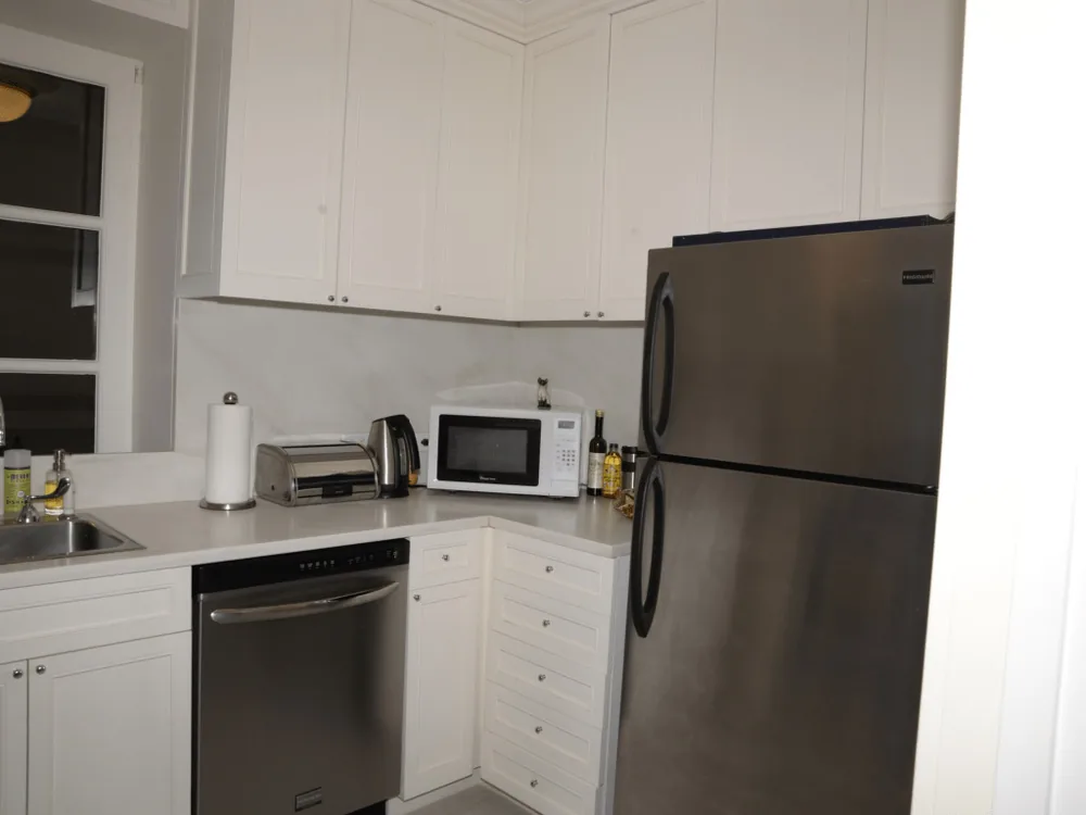 A kitchen countertop with a toaster and microwave small appliances